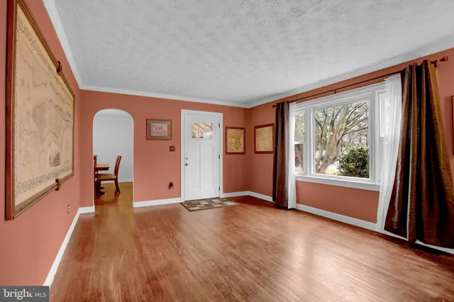 a view of a livingroom with furniture window and wooden floor