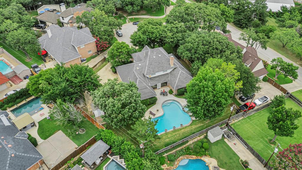 4008 Ramsgate Court Colleyville, TX 76034 - Photo 32 of 33 Residential property featuring an expansive backyard with a curvilinear swimming pool and surrounding paved patio