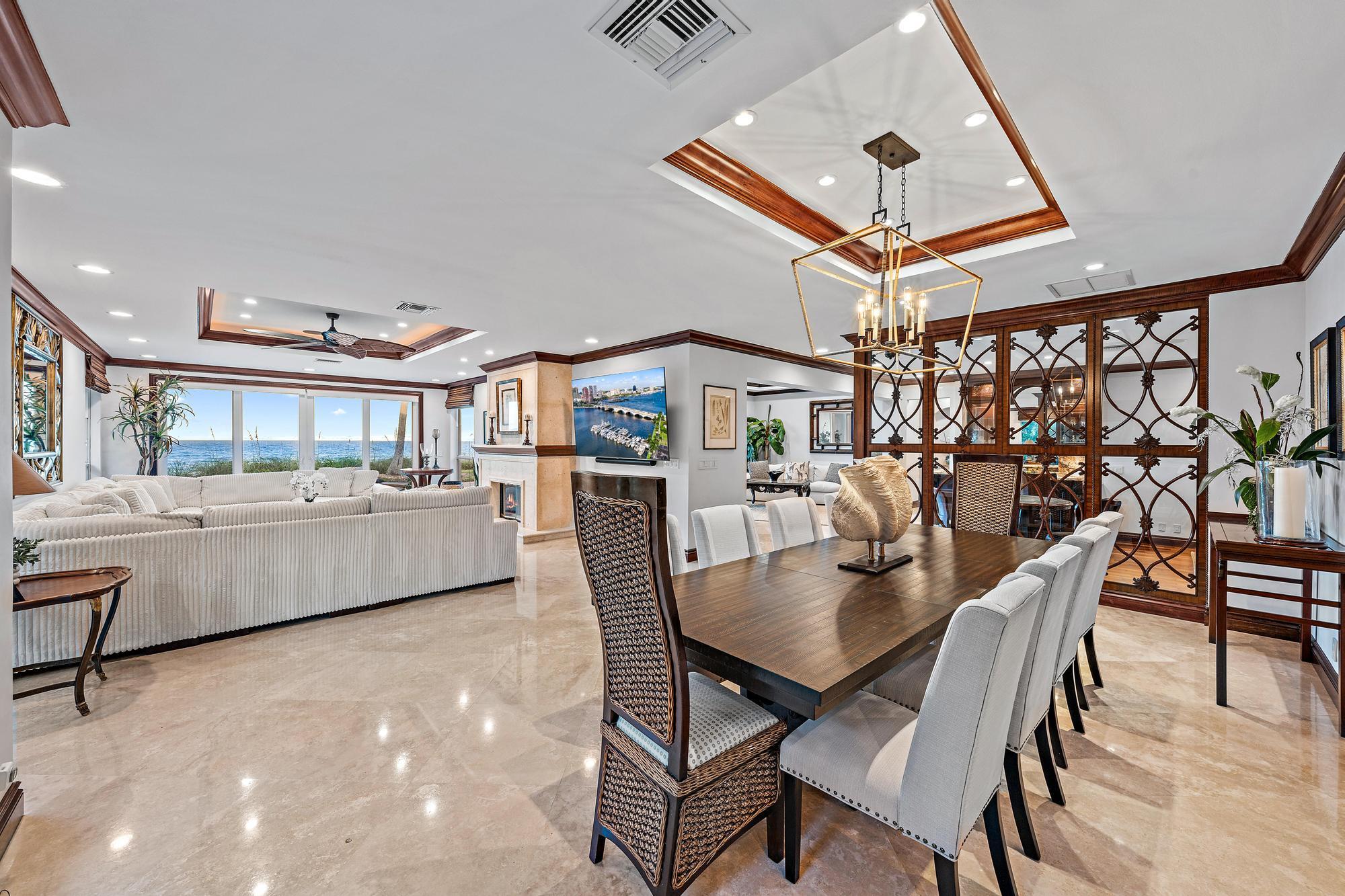 613 South Beach Road Jupiter, FL 33469 - Photo 30 of 74 a dining room with furniture and a ceiling fan