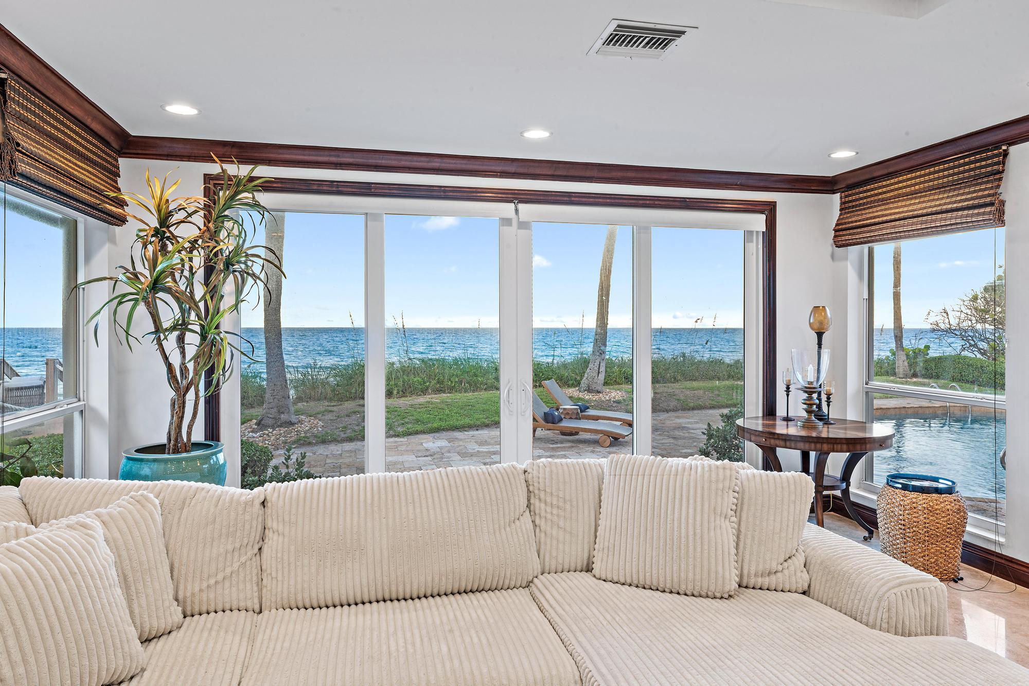 613 South Beach Road Jupiter, FL 33469 - Photo 33 of 74 a living room with furniture and a large window