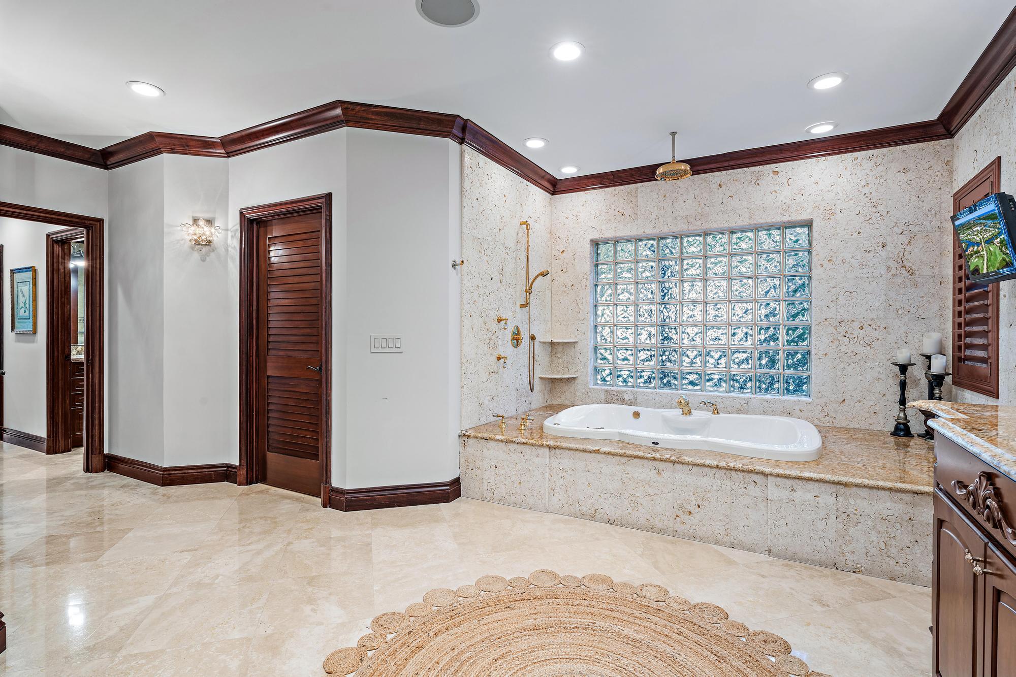 613 South Beach Road Jupiter, FL 33469 - Photo 51 of 74 a spacious bathroom with a large tub shower and sink