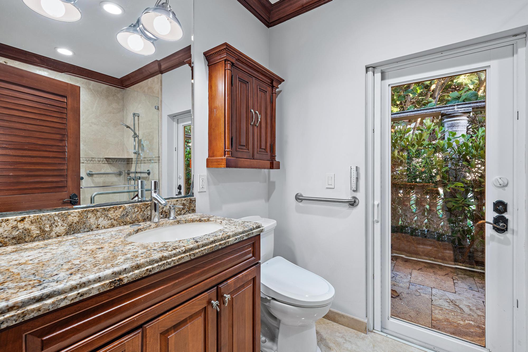 613 South Beach Road Jupiter, FL 33469 - Photo 55 of 74 a bathroom with a granite countertop sink a toilet a mirror and shower