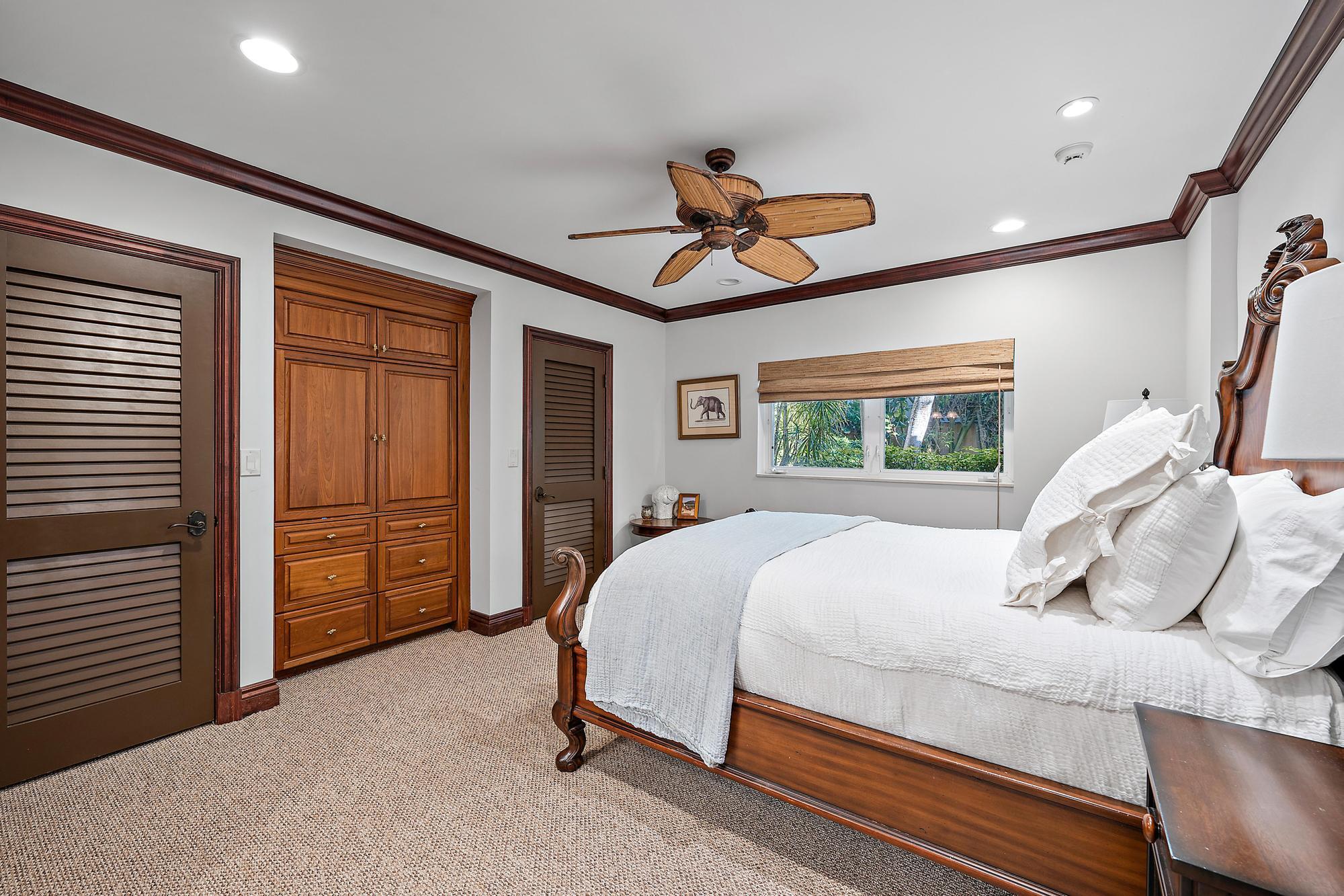 613 South Beach Road Jupiter, FL 33469 - Photo 62 of 74 a bedroom with a bed and a walk in closet