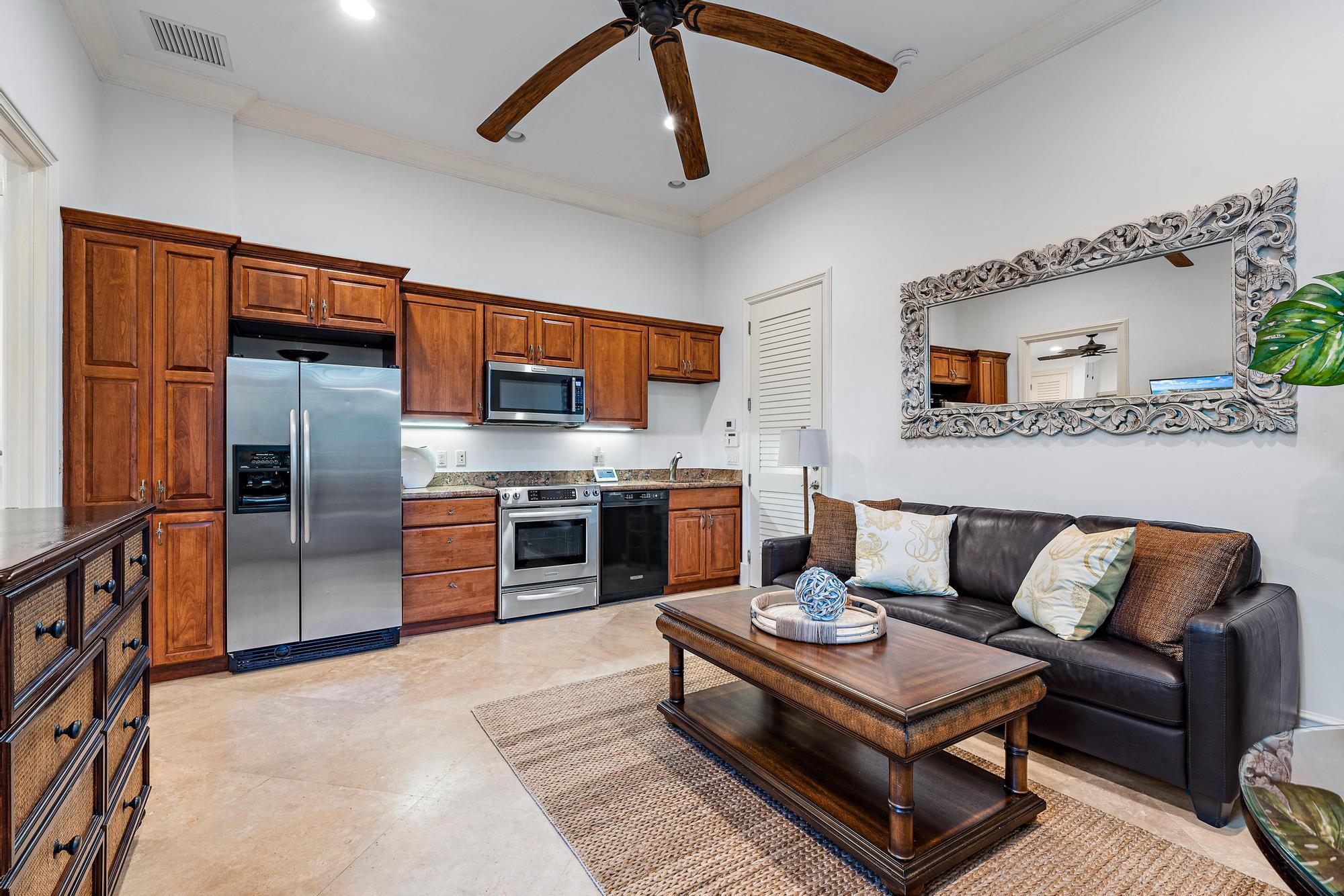 613 South Beach Road Jupiter, FL 33469 - Photo 68 of 74 a living room with stainless steel appliances furniture a rug and a kitchen view