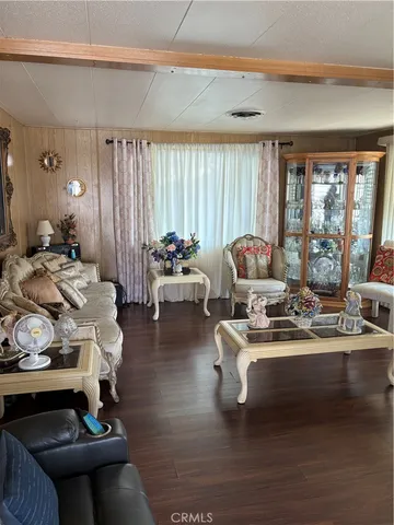a view of a dining room with furniture and a chandelier