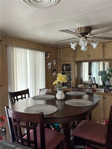 a kitchen with stainless steel appliances wooden floor dining table and chairs