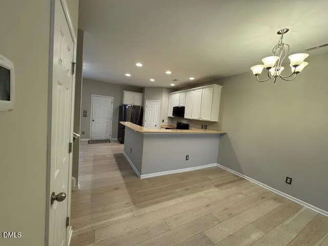 a view of a kitchen with a sink and cabinet area