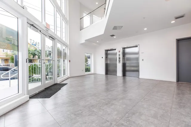 a room with gym equipment and windows