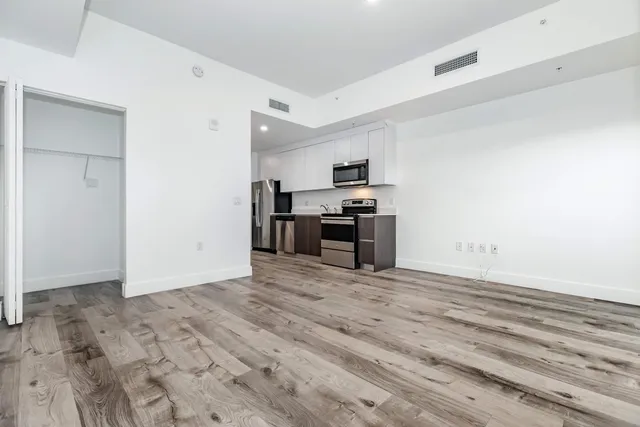 a view of kitchen with microwave and cabinets