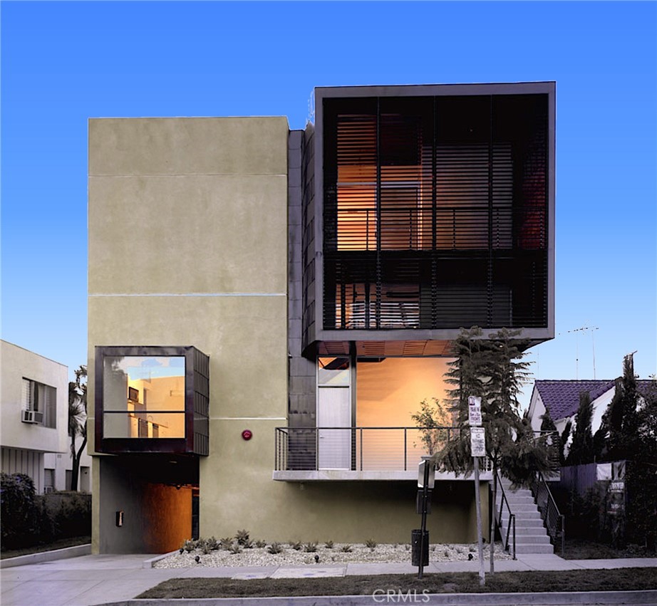 a view of building with car parked