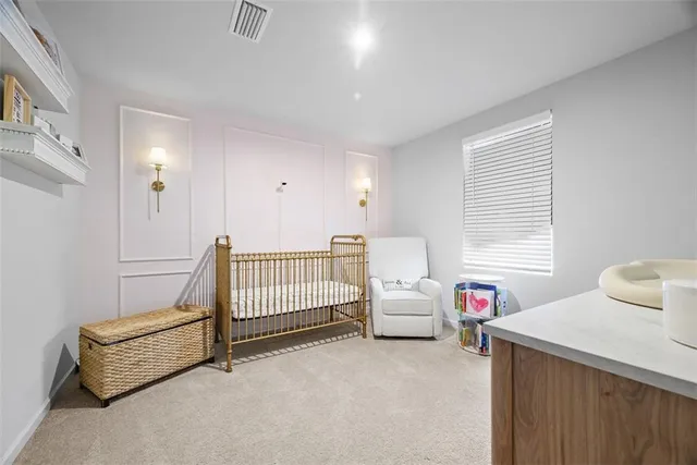 a view of room with baby crib and a window