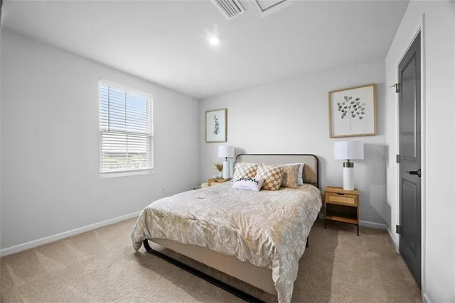 a bedroom with a bed and a lamp