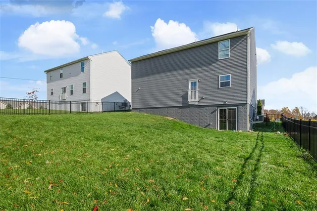 a view of a white house with a yard and plants