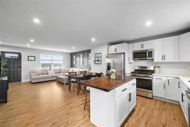 a kitchen with sink stove and refrigerator