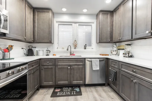a kitchen with a sink stove and cabinets
