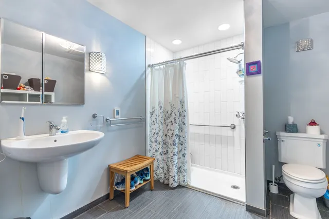 a bathroom with a sink toilet and shower