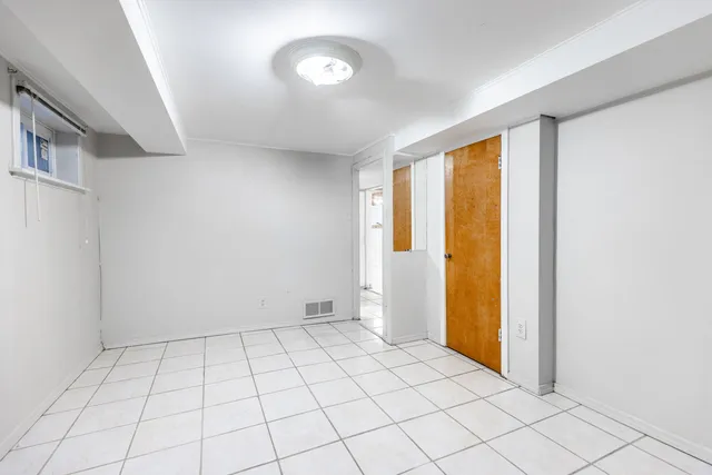 a bathroom with a granite countertop sink and a toilet