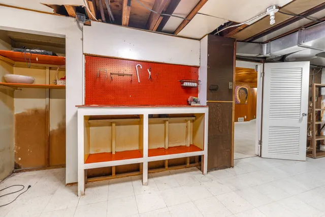 a bedroom with a bed couch and a large window