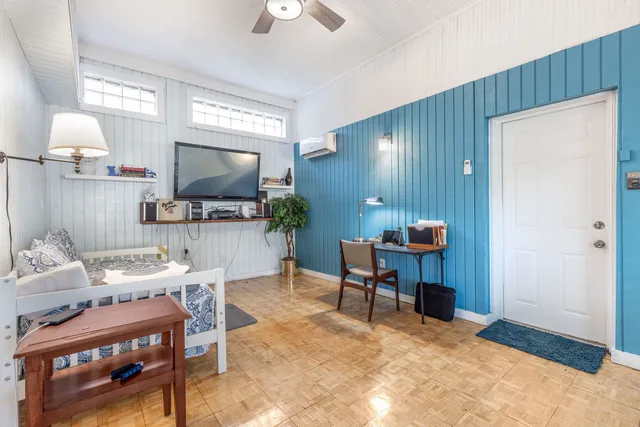 a living room with furniture and a flat screen tv