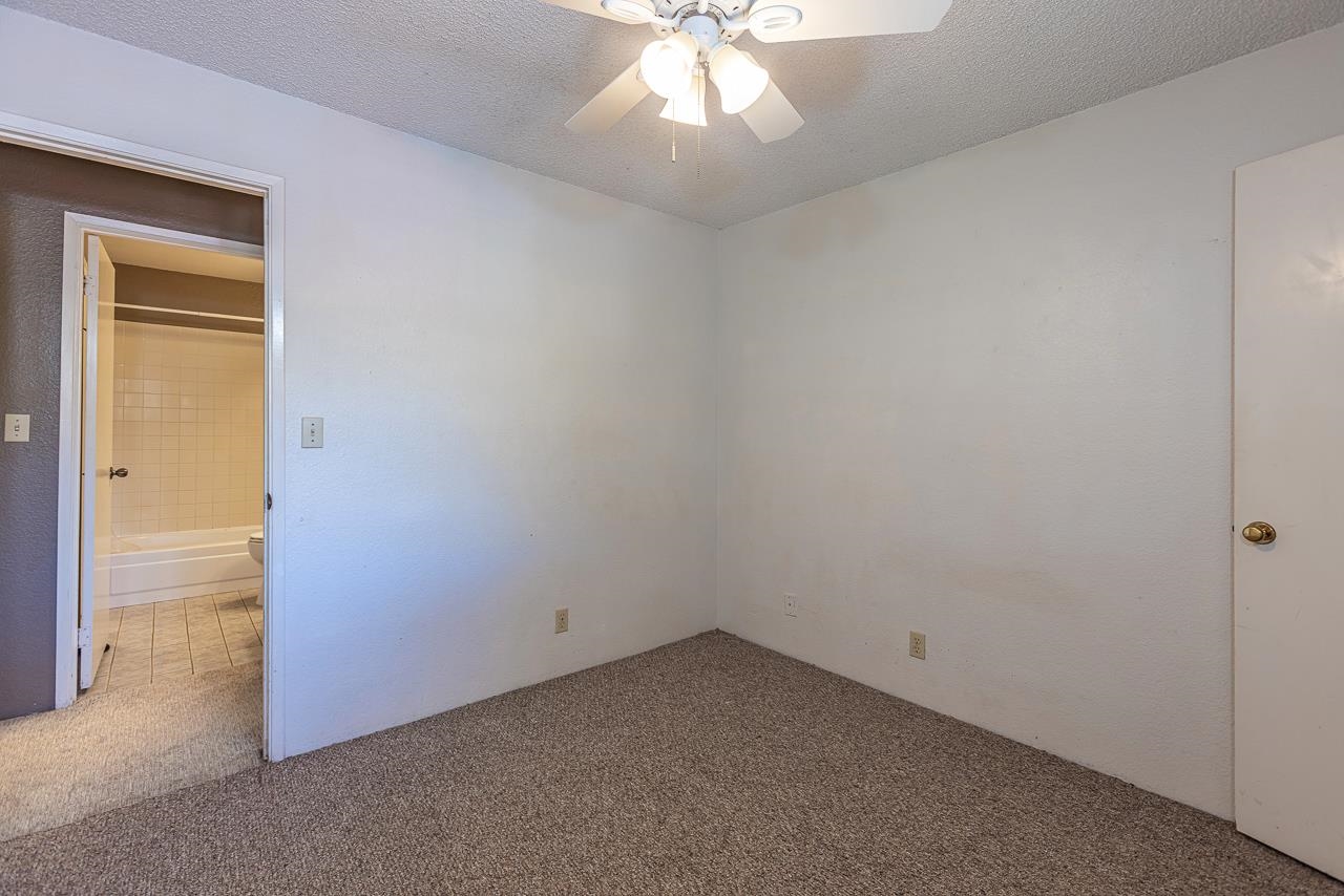 140 Uwapo Road, Unit 24202 Kihei, HI 96753 - Photo 13 of 45 an empty room with a window and a chandelier fan
