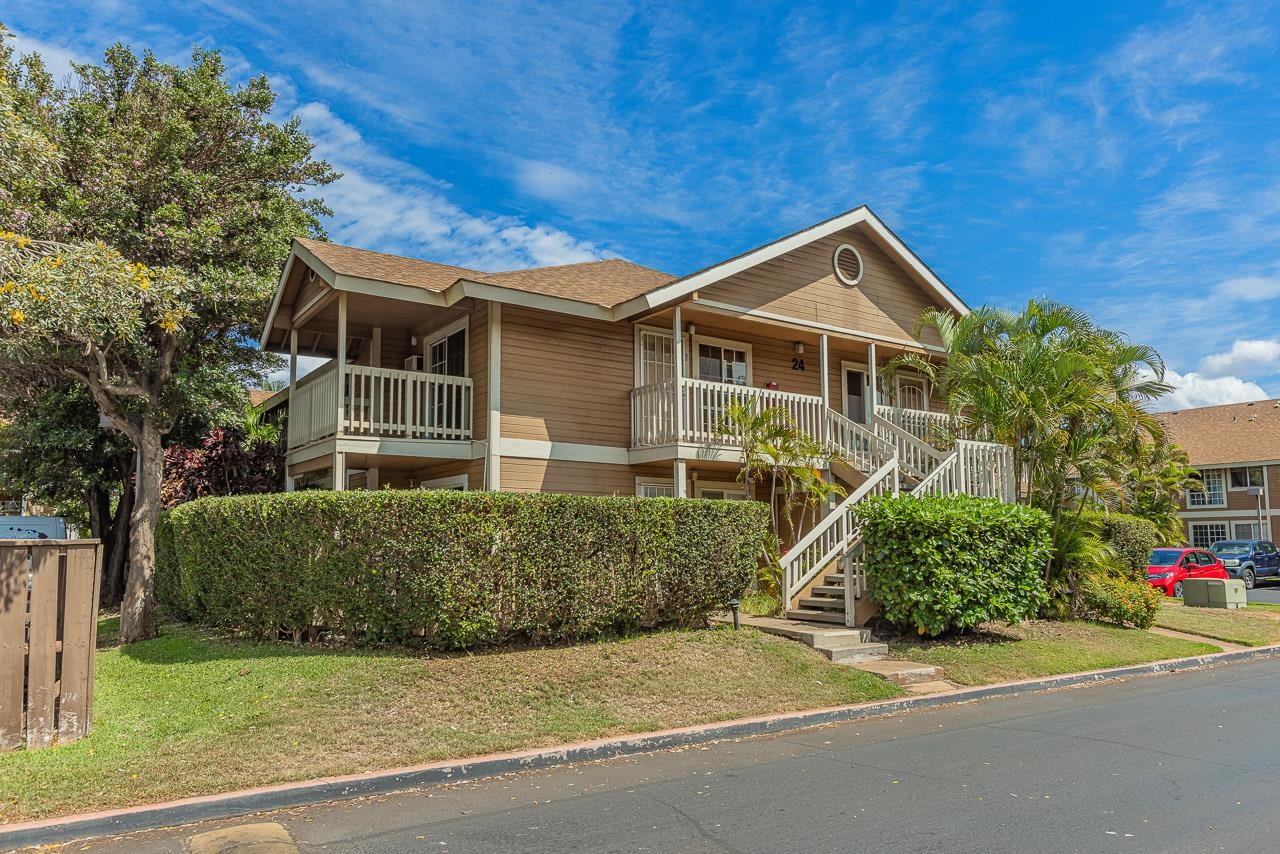 140 Uwapo Road, Unit 24202 Kihei, HI 96753 - Photo 31 of 45 a front view of a house with a yard and garage