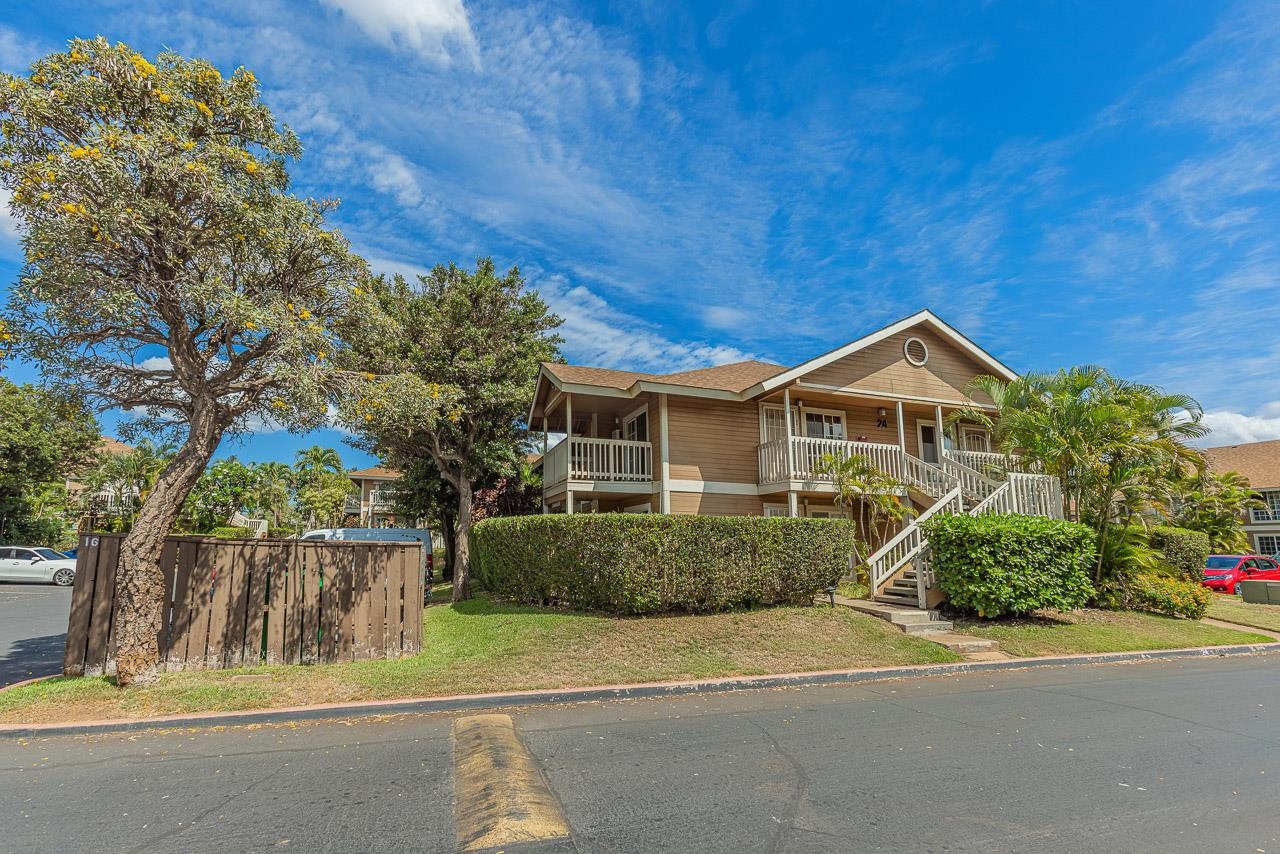 140 Uwapo Road, Unit 24202 Kihei, HI 96753 - Photo 34 of 45 a front view of a house with a yard and garage