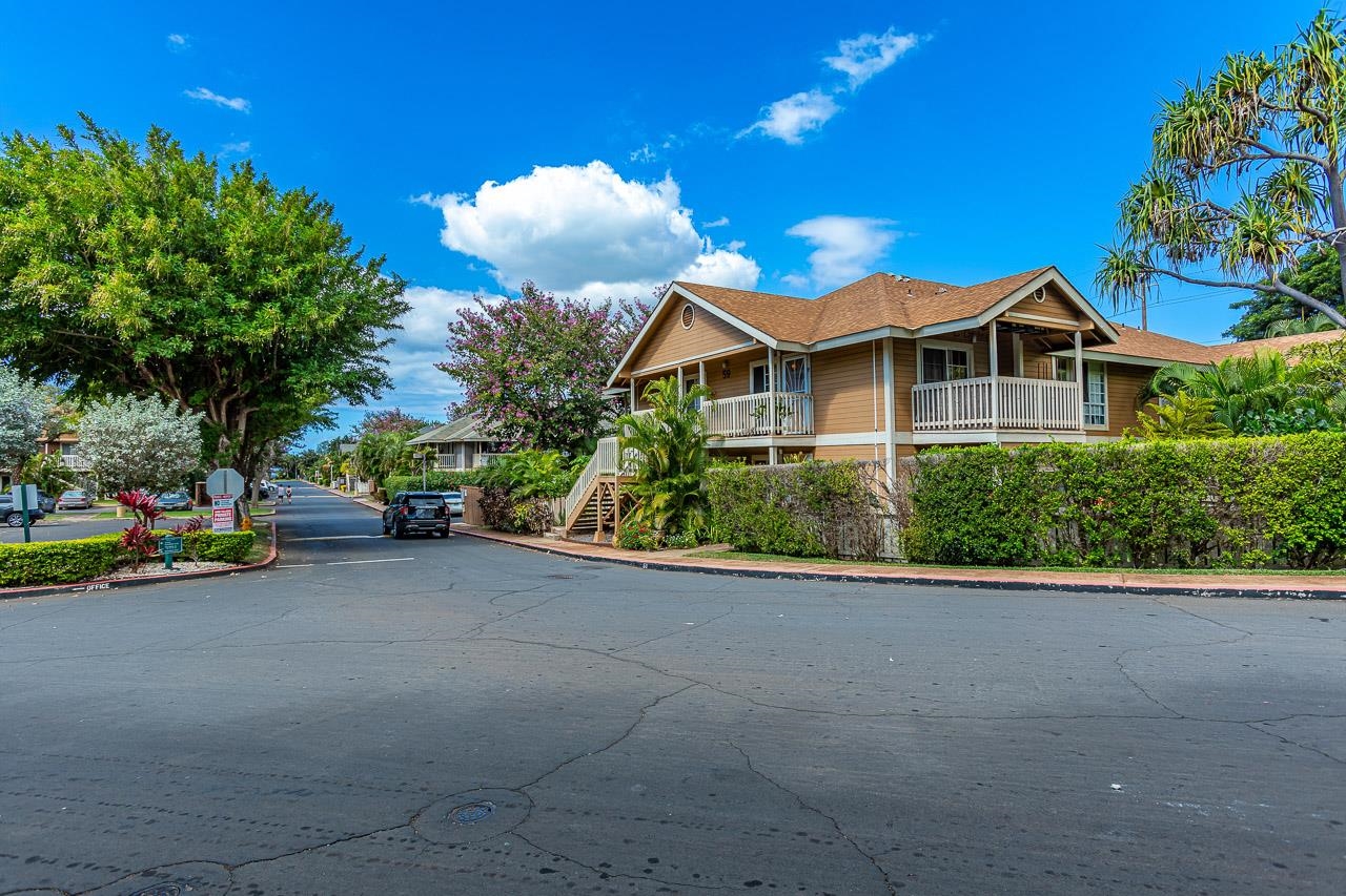 140 Uwapo Road, Unit 24202 Kihei, HI 96753 - Photo 41 of 45 a view of a house with a cars park next to a road