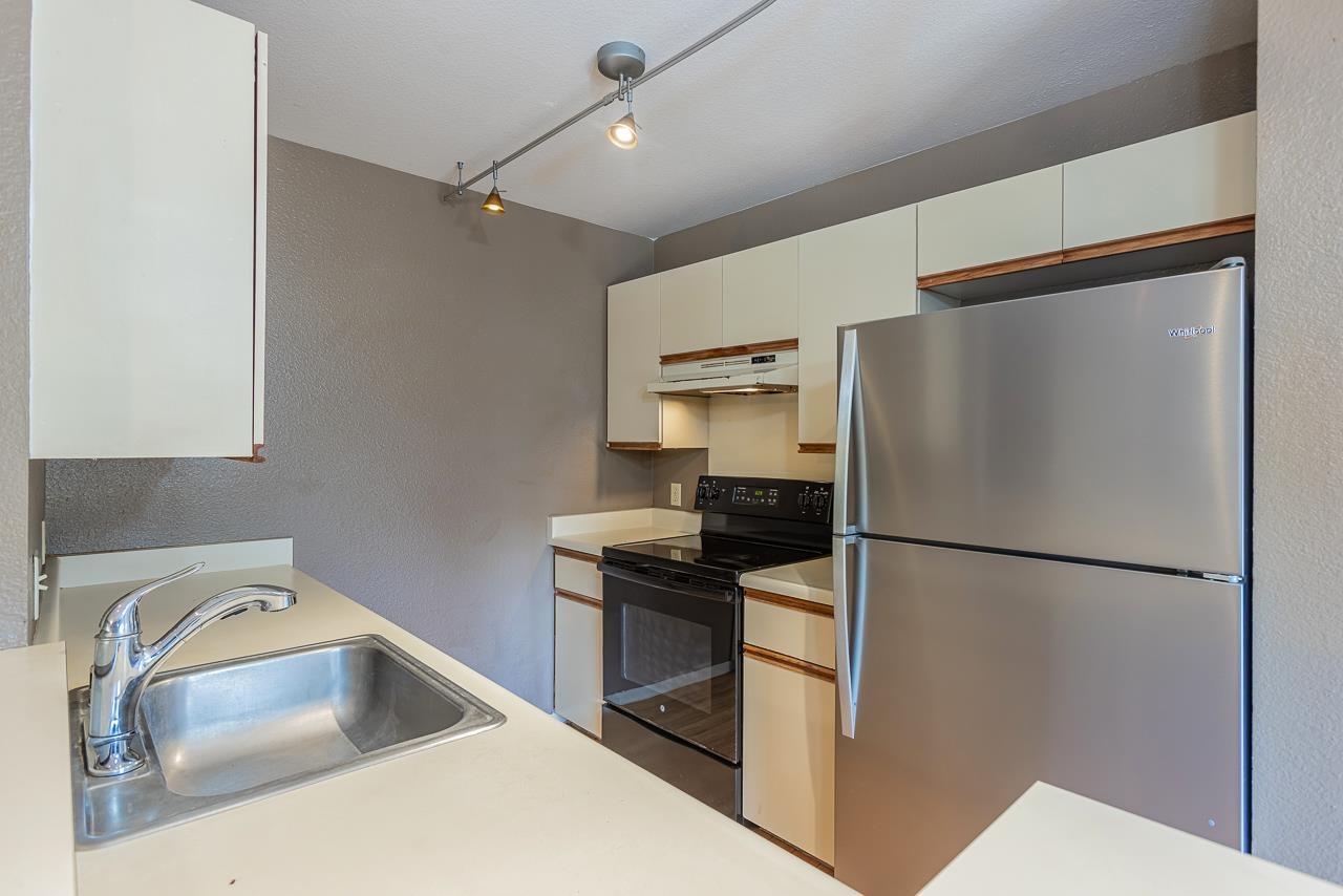 140 Uwapo Road, Unit 24202 Kihei, HI 96753 - Photo 10 of 45 a kitchen with a refrigerator sink and stove