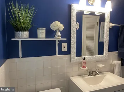 a bathroom with a sink a mirror and a toilet
