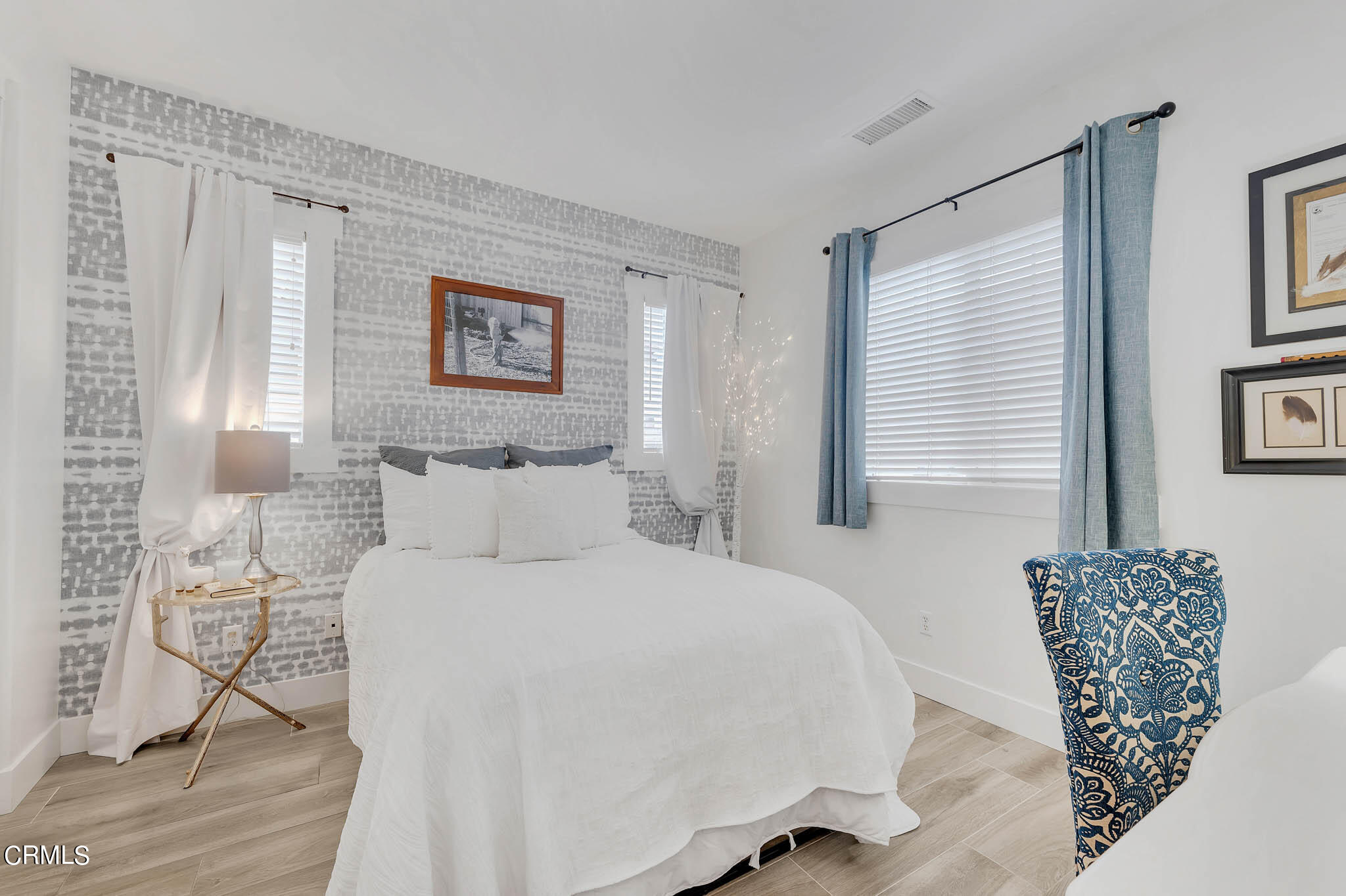 1465 Donegal Way Oxnard, CA 93035 - Photo 29 of 45 a bedroom with a bed and wooden floor