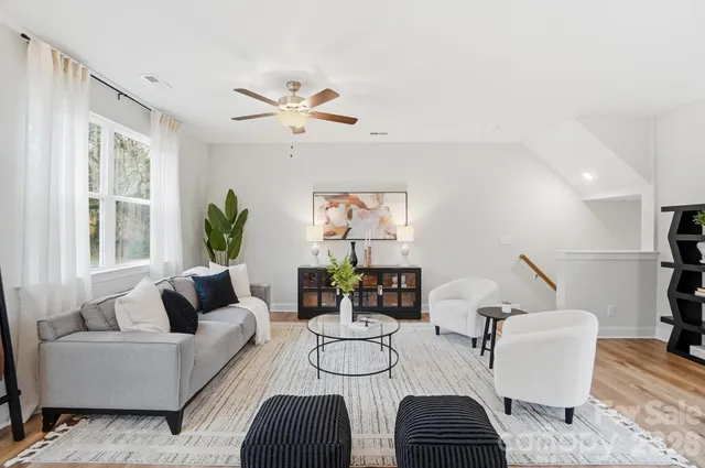 a living room with furniture potted plant and a window