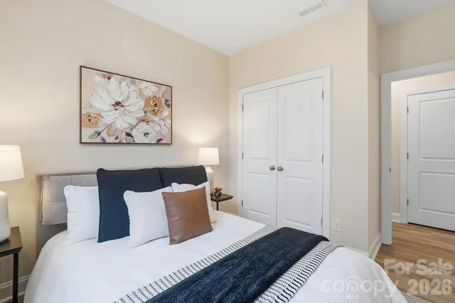 a bedroom with a bed and painting on the wall