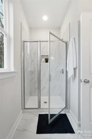 a view of a bathroom with a glass door shower