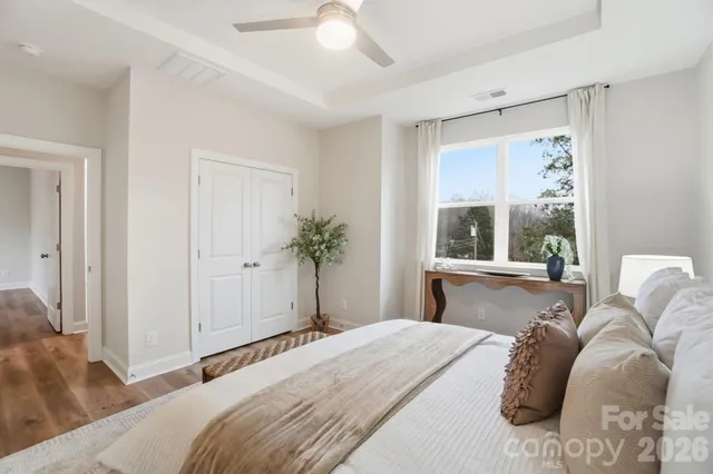 a bedroom with a bed and a large window