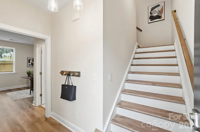 a view of entryway and hall with wooden floor