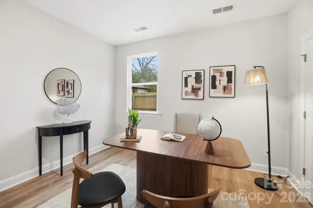 a room with a toilet a rug and a window