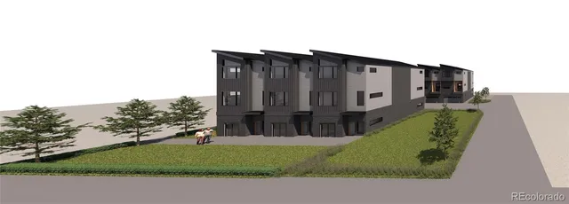 a green field with some trees in the background