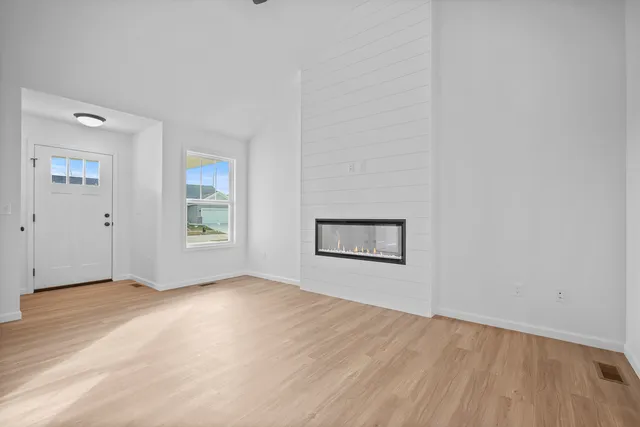 an empty room with windows and closet