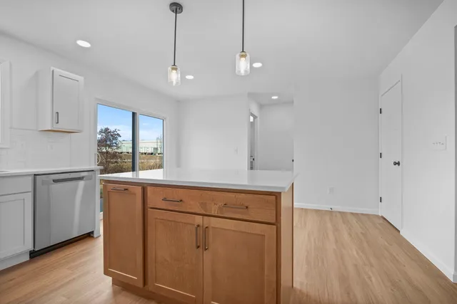 a kitchen with a wooden floor and window