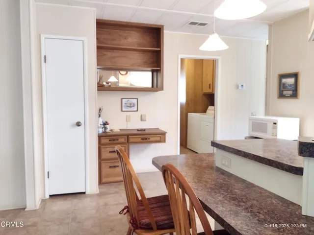 a large kitchen with a table and chairs
