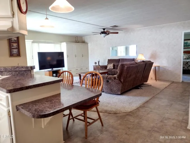 a living room with furniture a flat screen tv and a table
