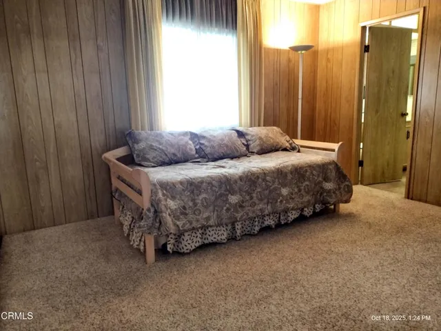 a spacious bedroom with a bed and a window