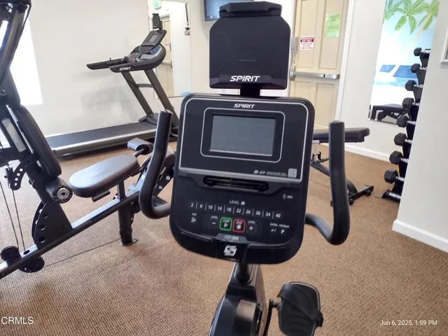 a room with gym equipment and windows