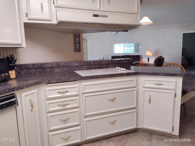 a kitchen with cabinets appliances and a counter space