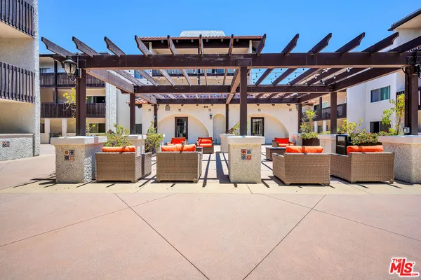 a view of a patio with table and chairs potted plants