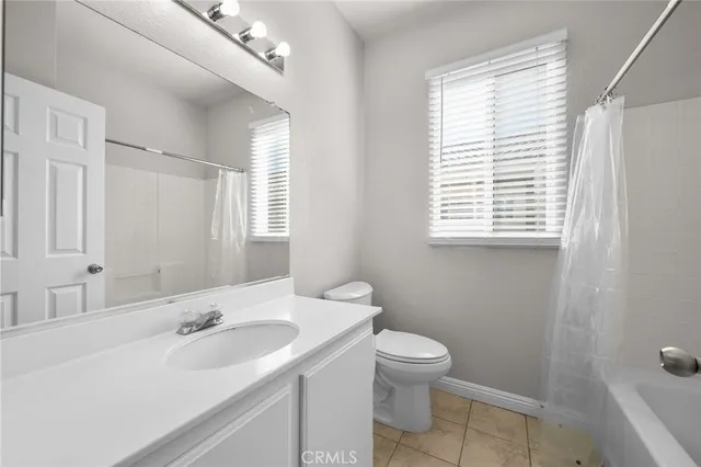 a bathroom with a sink toilet and mirror