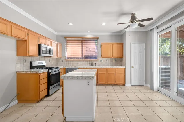 a kitchen with stainless steel appliances granite countertop a stove a sink and a refrigerator