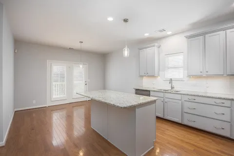 a kitchen with granite countertop white cabinets and white appliances