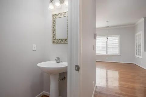 a bathroom with a sink a mirror and a window