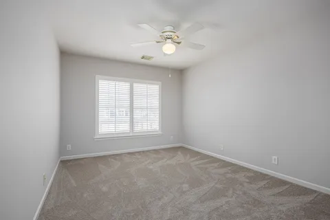 a view of an empty room and a window